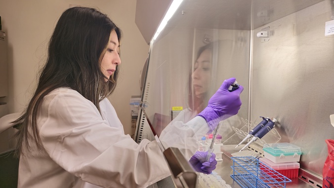 A researcher works in a laboratory at the UH Cancer Center